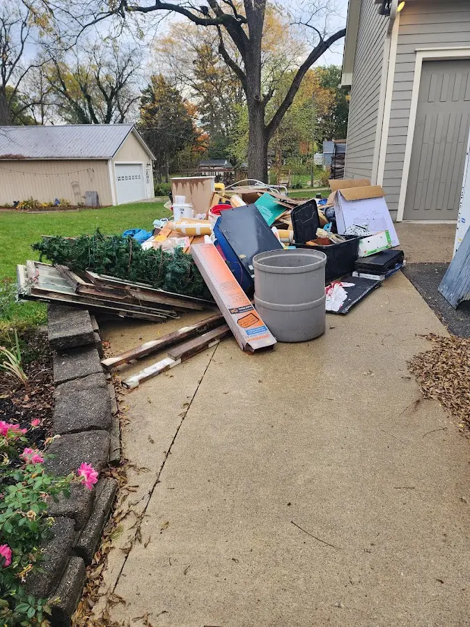 Dumpster being loaded with debris for Estate Cleanout Dumpster Rental in Staples